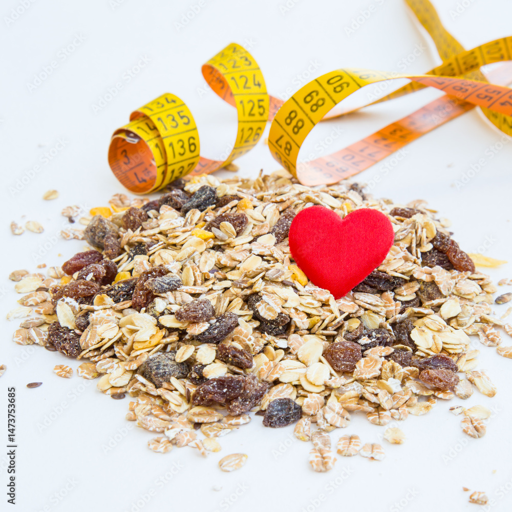 pile of muesli, heart and measurement tape