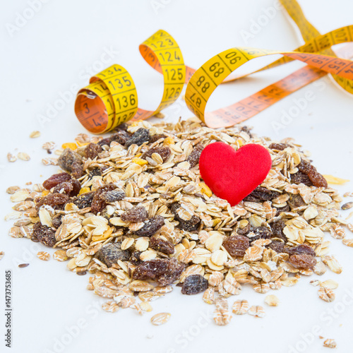 Obraz na płótnie pile of muesli, heart and measurement tape w salonie