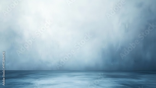 Empty, muted blue studio backdrop with soft, hazy texture