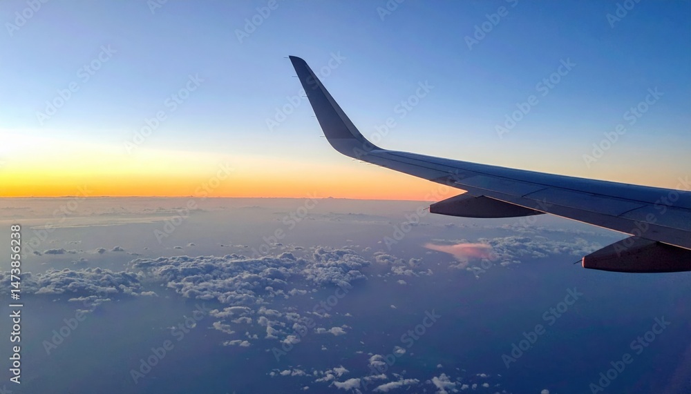 Obraz premium Aerial sunset views from airplane wing above the clouds travel photography serene atmosphere wide angle perspective dreamy skies