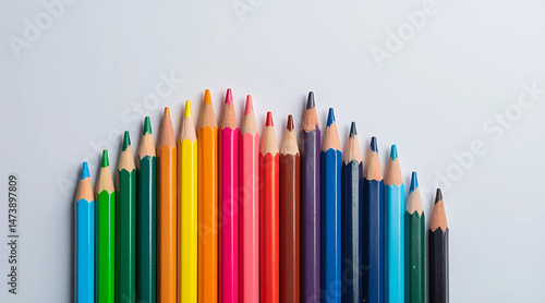 Top View of Colorful Pencils Aligned in Rainbow Order on Light Gray Background – Back to School Concept.
