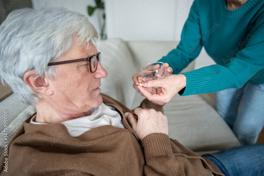 Εκτύπωση καμβά Struggling sad pensioner taking pills from wife hand before fall