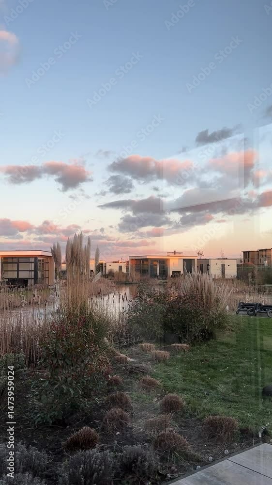 Beautiful sunset view over modern buildings by the water highlights serene evening atmosphere Beautiful sunset view over modern buildings by the water highlights serene evening atmosphere