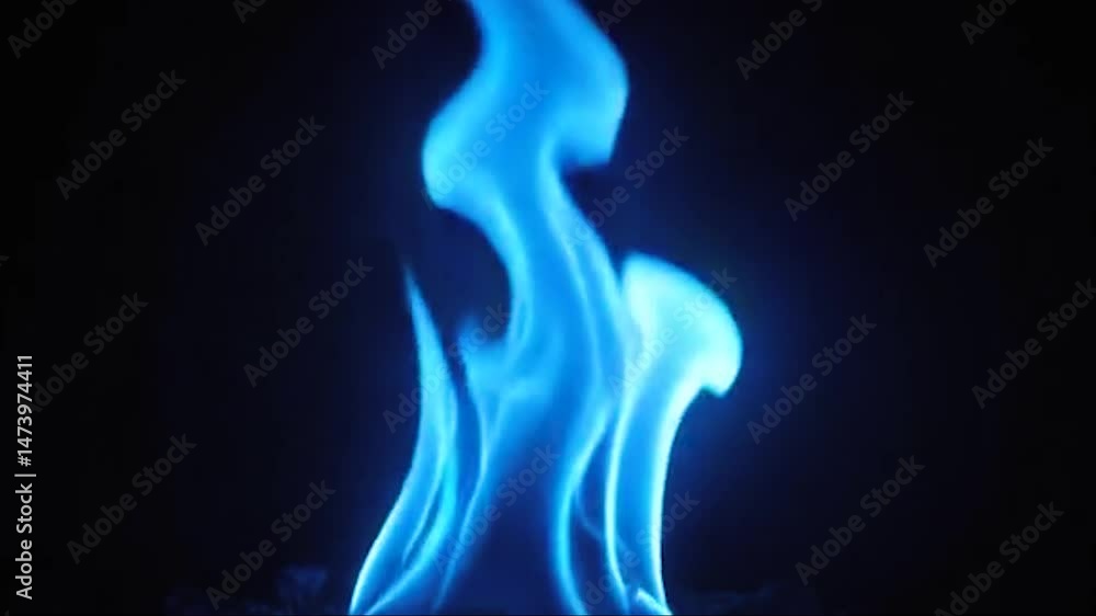 Blue smoke curves like a smooth wave against the black background Blue smoke curves like a smooth wave against the black background