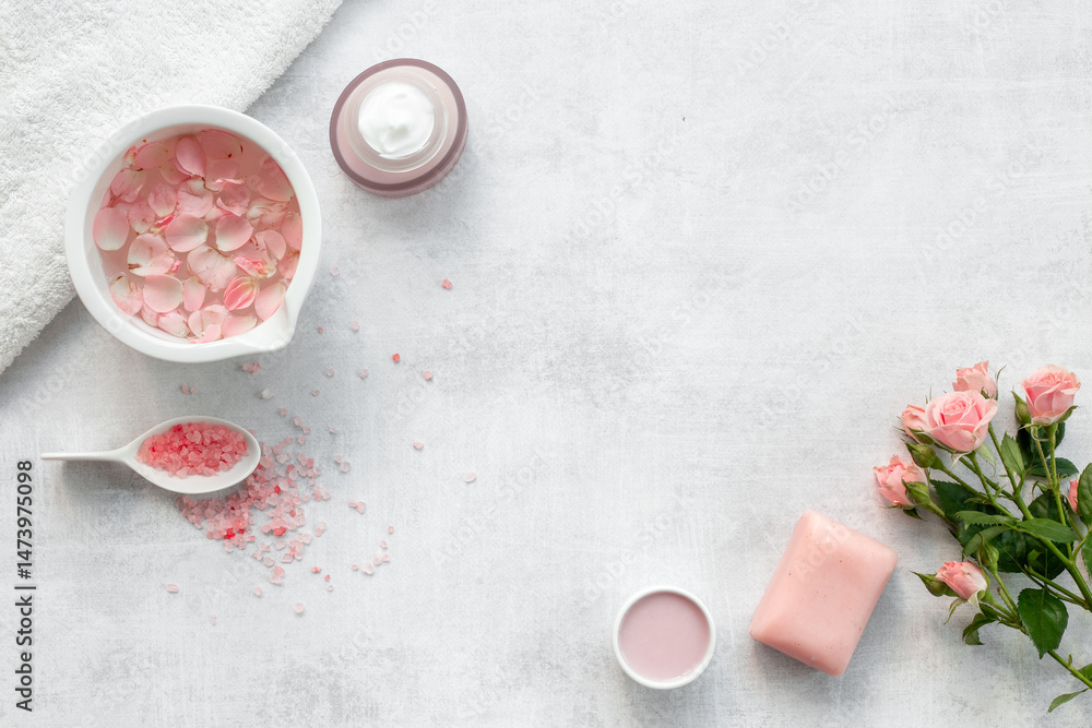 Spa and beauty routine concept with pink roses and essence water with petals Spa and beauty routine concept with pink roses and essence water with petals
