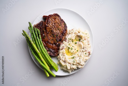 Traditional steak and mashed potatoes with blanched asparagus