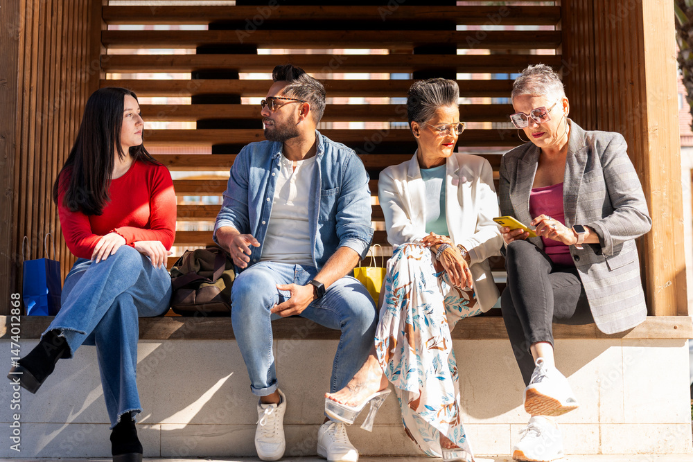 Fototapeta premium Group of diverse friends relaxing together after shopping spree