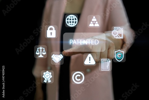 A person in a pink jacket touches a floating digital interface with 