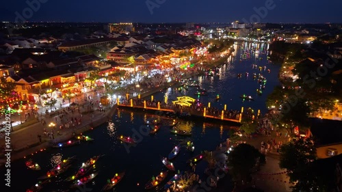 Aerial view of Hoi An old town or Hoian ancient town in evening. Royalty high-quality free stock footage top of Hoai river and boat tour night traffic. One of the most popular touristic destination