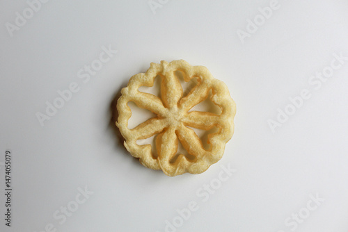 Kembang goyang cake, traditional snack from Indonesia. Fried dough in wheel or flower shaped. Isolated on white backgroun
