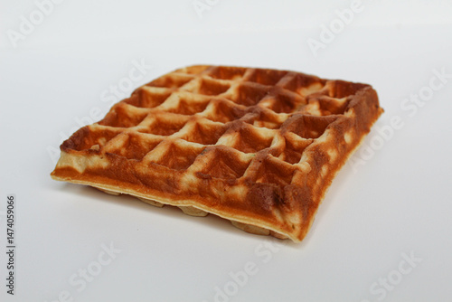 One plain square waffle cake, burnt side, isolated on white background