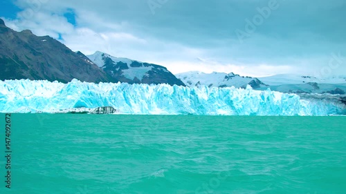 Wallpaper Mural Perito Moreno Glacier in Argentina displays towering ice formations glistening against a turquoise lake, surrounded by rugged mountains and dramatic skies. Torontodigital.ca