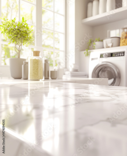 A close-up of a marble countertop in a bright laundry room, with a washing machine in the background and natural light streaming through large windows. 