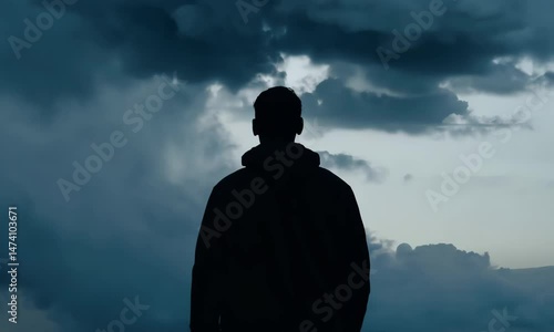 Silhouette of a person in a stormy landscape