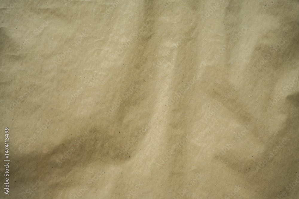 Obraz premium Textured close-up of crumpled brown recycled paper. Ideal as a background, texture, or design surface.