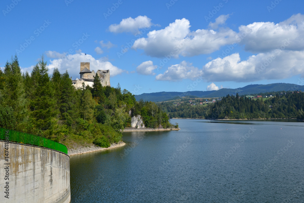 Fototapeta premium Lake Czorsztyn and medieval castle in Niedzica. The beauty of nature and architecture in Southern Poland. Medieval Castle in Niedzica, built in 14th century and artificial Czorsztyn Lake