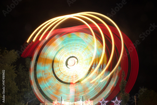 Captivating long exposure of colorful amusement park ride