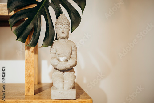 Buddha Statue with Leaf Background for Tranquil Decor