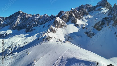 Cortina d'Ampezzo, Italy: Aerial view of famous ski resort in Dolomites (Dolomitic Alps)  and venue of Winter Olympics Milano Cortina 2026, sunny day - landscape panorama of Europe from above
