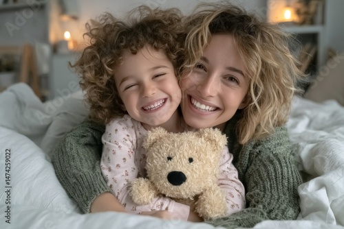As morning arrives, a happy mother strokes her little daughter to wake her from sleep