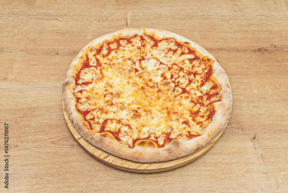 A delicious margherita pizza on a round wooden board A delicious margherita pizza on a round wooden board