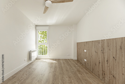 A newly renovated unfurnished room with wooden floors and walls