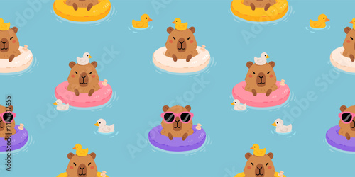 Cute minimalistic vector cartoon background with relaxed capybara swimming on an inflatable ring with rubber ducks. Fun summer seamless pattern