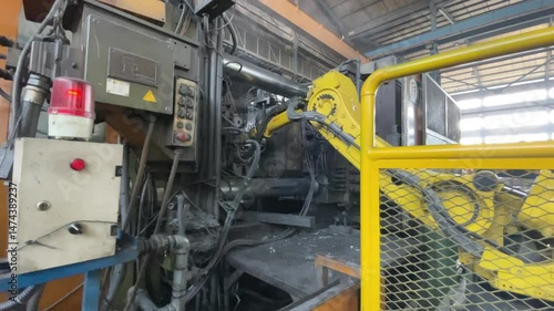 Automated Industrial Machine Molding Metal Components in Manufacturing Facility