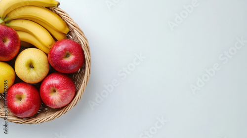 Beautifully arranged fruit basket featuring ripe bananas, red apples, and yellow apples, evoking freshness and health