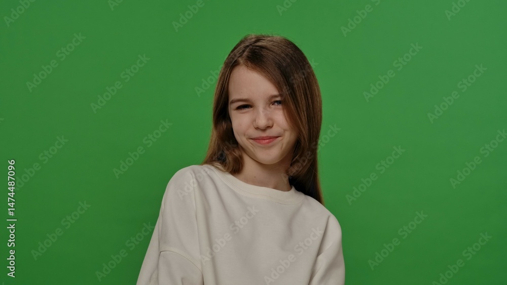 Obraz premium Teenage girl posing at camera, positive expression, isolated on chroma key green screen studio background mockup.