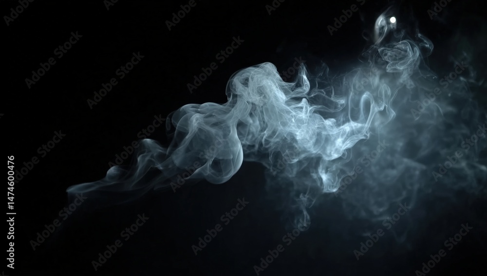 Fototapeta premium Wisps of white smoke swirl gracefully against a dark black background.