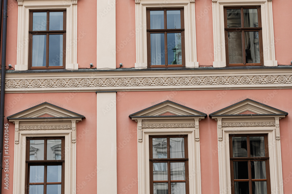 Elegant facade with symmetrical decorated windows and architectural details in Lviv, Ukraine. Elegant facade with symmetrical decorated windows and architectural details in Lviv, Ukraine.