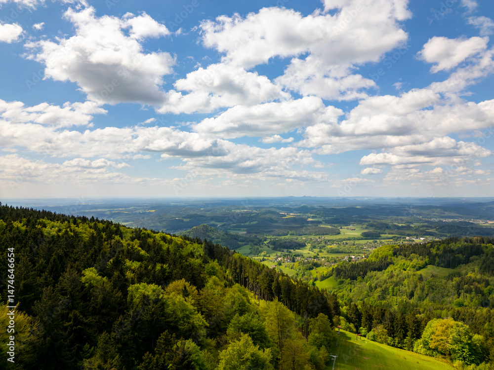 Obraz premium Aerial view of blooming summer landscape near Jizera Mountains with green hills, forests, meadows and picturesque villages, including views toward Jested mountain in Czech Republic
