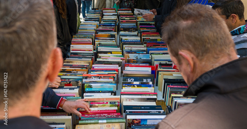People looking for some books and second hand items in a flea market