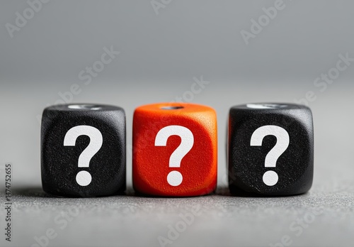 Three dice, two black, one orange, all displaying question marks.  A visual representation of uncertainty
