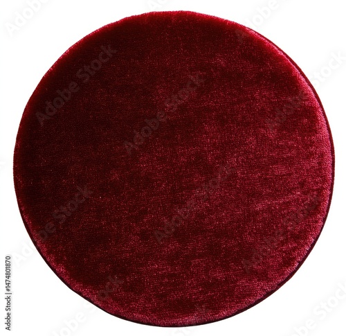 Deep maroon circular cushion, plush velvet texture