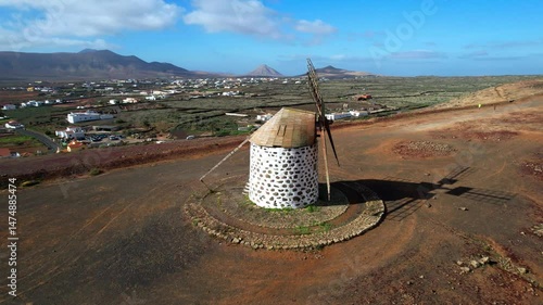 Traditional old spanish windmills in La Oliva village, Fuerteventura Canary island of Spain. Aerial drone 4k hd video
