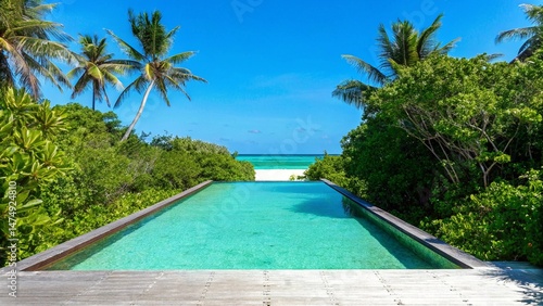 Fototapeta Naklejka Na Ścianę i Meble -  A luxurious swimming pool at a tropical beach resort offers the perfect summer vacation for relaxation under the palm trees and blue sky