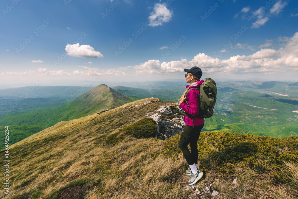Obraz premium Young Woman with Backpack Traveling in Mountains