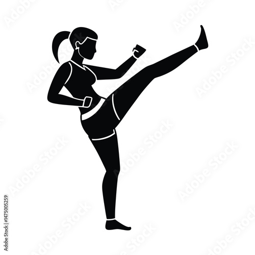 Silhouette of a woman kicking high during martial arts exercise fitness or self defense training