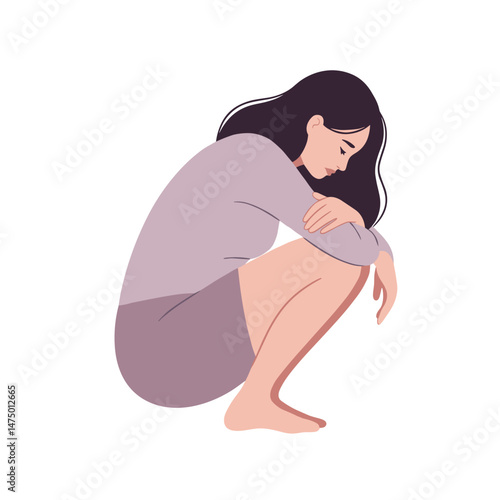 Woman sitting sadly in a squatting position with a simple background  