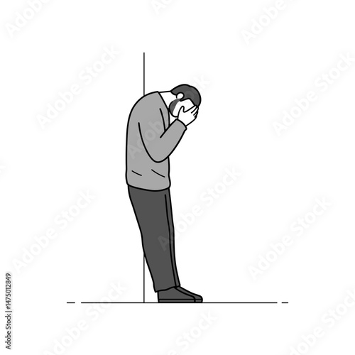 Sad man leaning against wall with hands over face  