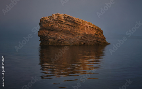 Solitary Rock Formation Misty Water Reflection