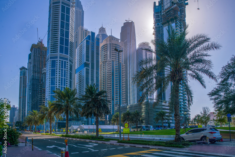 Panorama od Dubai with lakes (!) and awe public park with palms along road and cars traffic