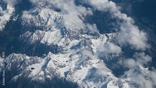 Wallpaper Mural Flight over snow-capped mountains. View through airplane window on white mountain peaks. Alps in Austria. Torontodigital.ca