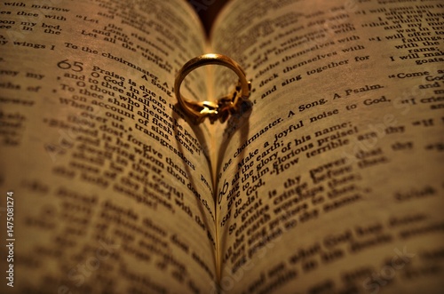 ring casting heart-shaped shadow in a bible