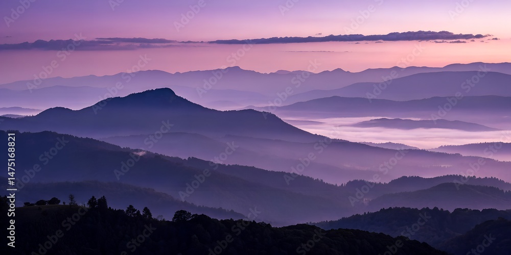 Obraz premium Serene mountain range landscape displays a captivating purple and violet sunrise with layers of misty fog and silhouettes