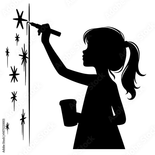 Silhouette of girl painting sparkles on a wall