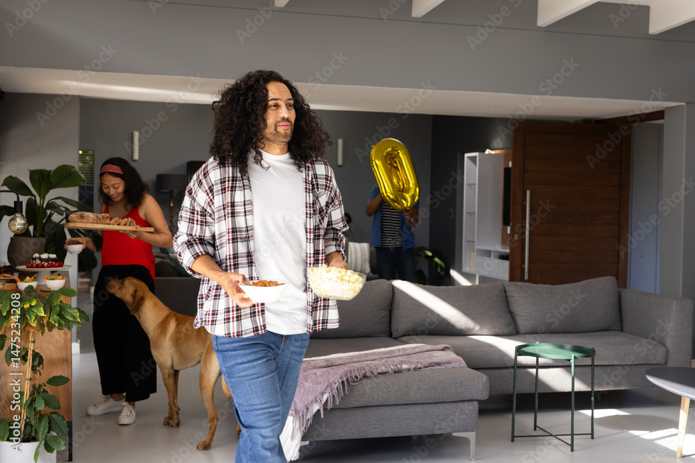 Obraz premium Man carrying snacks while woman and child with balloon prepare for celebration
