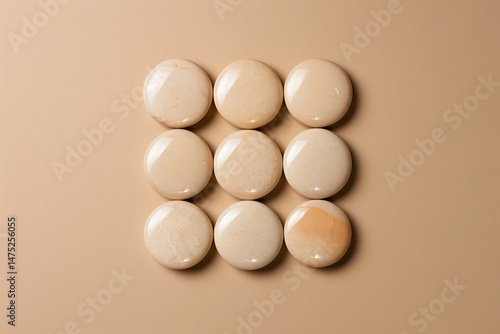 Aesthetic arrangement of smooth, round beige stones on a neutral background, showcasing a minimalist design with calming tones and soft textures.